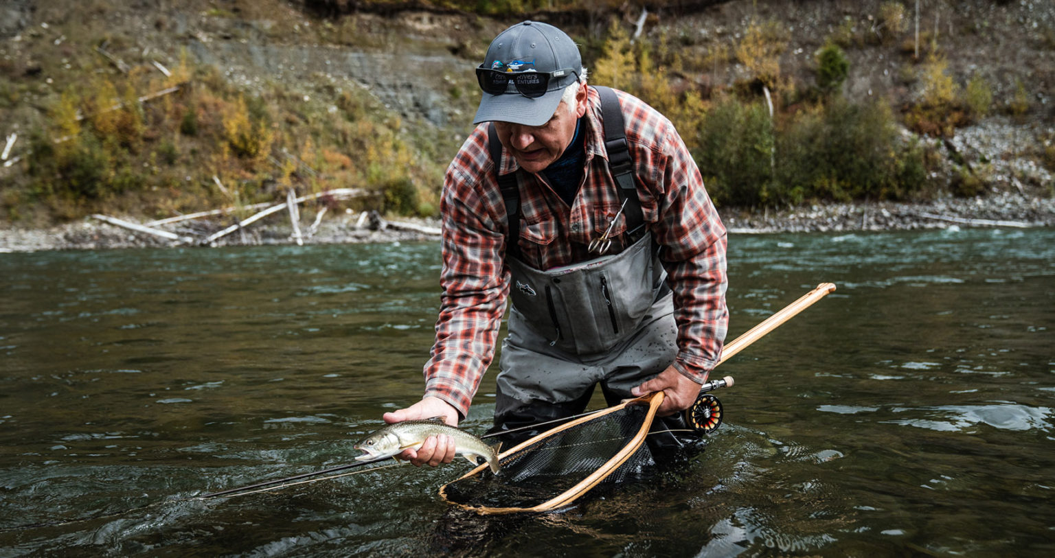 Man catching fish in river with net