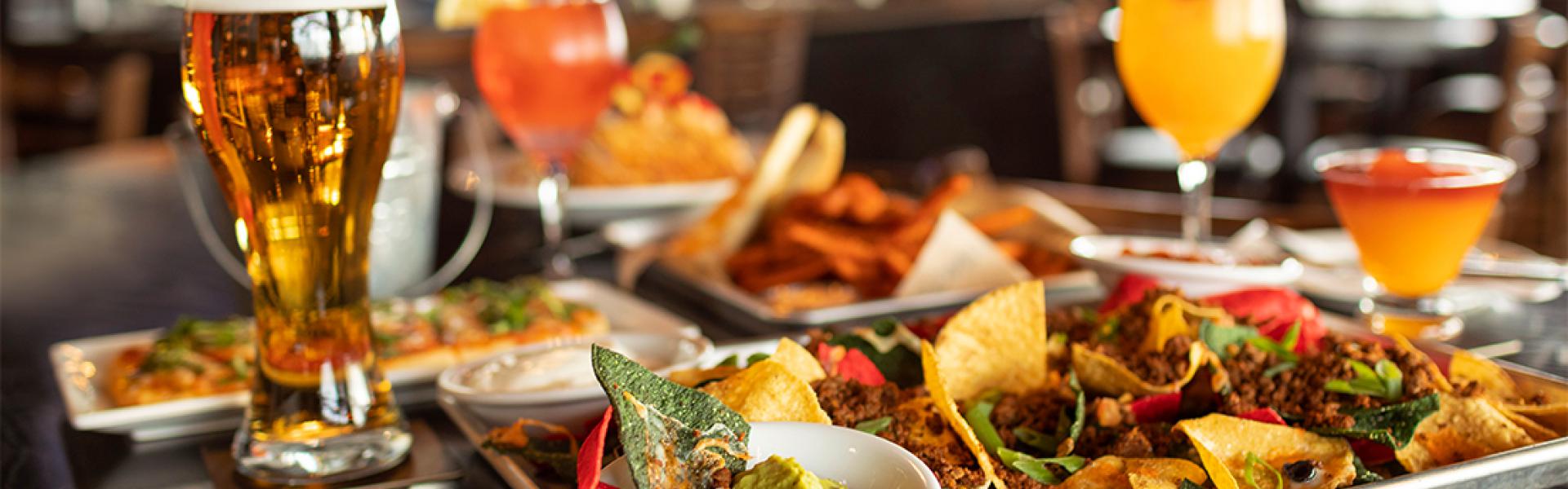 Nachos with guacamole, Pizza and Fries A glass of Beer , juice