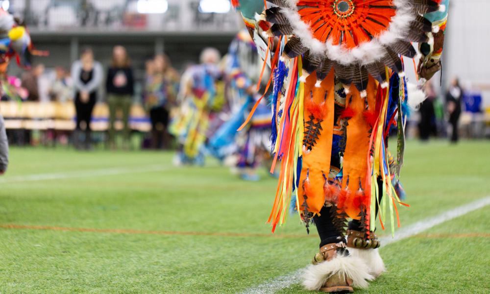 Person wearing traditional Regalia at a community Pow Wow