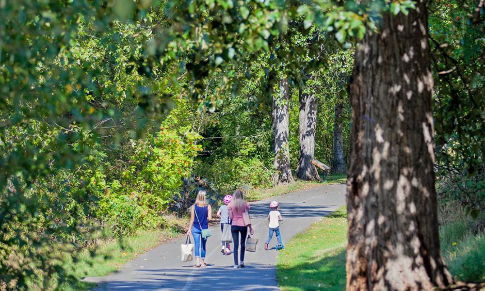 Mothers and daughters walking on paved Riverfront Trail